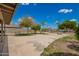 Large backyard featuring a basketball hoop, mature trees, and ample space for outdoor activities and entertaining at 1145 E Harold Dr, San Tan Valley, AZ 85140