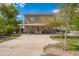 Large backyard with a covered patio, mature trees, and ample space for outdoor gatherings and leisure at 1145 E Harold Dr, San Tan Valley, AZ 85140