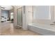 Bright bathroom with walk-in shower, soaking tub, and tile flooring at 1145 E Harold Dr, San Tan Valley, AZ 85140
