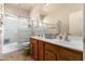 Bathroom with double sinks, bath tub, shower, and ample counter space at 1145 E Harold Dr, San Tan Valley, AZ 85140
