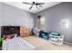 Comfortable bedroom with a ceiling fan and a window that provides natural light at 1145 E Harold Dr, San Tan Valley, AZ 85140
