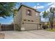 Angle view of the front of the home featuring a spacious two-car garage and landscaped yard at 1145 E Harold Dr, San Tan Valley, AZ 85140