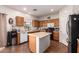 The kitchen features wood cabinets, an island, and recessed lighting at 1145 E Harold Dr, San Tan Valley, AZ 85140