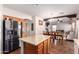 Kitchen with island, wood cabinets and stainless steel refrigerator at 1145 E Harold Dr, San Tan Valley, AZ 85140