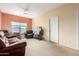 Living room with ceiling fan, window, and comfortable seating at 1145 E Harold Dr, San Tan Valley, AZ 85140