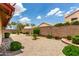The backyard features landscaping with gravel ground cover and mature trees at 11524 W Rosewood Dr, Avondale, AZ 85392