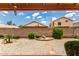 View of the backyard featuring desert landscaping, block fence, and covered patio at 11524 W Rosewood Dr, Avondale, AZ 85392