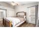 Bedroom featuring wood-look floors and doors to the exterior at 11524 W Rosewood Dr, Avondale, AZ 85392