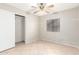 Bedroom with a ceiling fan, window, and closet, providing comfort and functionality at 11524 W Rosewood Dr, Avondale, AZ 85392