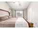 Bedroom with wood-look floors and large window at 11524 W Rosewood Dr, Avondale, AZ 85392