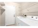 A convenient laundry room with washer, dryer, and storage shelves at 11524 W Rosewood Dr, Avondale, AZ 85392