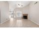 Spacious living room with tile floors and a fireplace, creating a cozy yet open atmosphere at 11524 W Rosewood Dr, Avondale, AZ 85392
