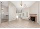 Bright living area with tile flooring, fireplace, and kitchen view, perfect for entertaining at 11524 W Rosewood Dr, Avondale, AZ 85392