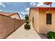 A side yard with neutral tones, gravel, and a row of ornamental plants at 11524 W Rosewood Dr, Avondale, AZ 85392
