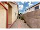 View of the side yard with desert landscaping, block fence, and walkway at 11524 W Rosewood Dr, Avondale, AZ 85392
