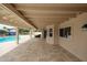 View of the spacious back patio featuring travertine floors and a refreshing pool at 12448 N 76Th St, Scottsdale, AZ 85260