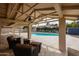 Comfortable patio seating offers the perfect place to relax by the pool in the backyard at 12448 N 76Th St, Scottsdale, AZ 85260