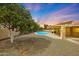 Backyard with desert landscaping, pool, patio and covered seating area at 12448 N 76Th St, Scottsdale, AZ 85260