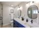 Stylish bathroom with dual sinks, modern fixtures, and decorative mirrors at 12448 N 76Th St, Scottsdale, AZ 85260