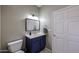 Comfortable bathroom with a dark blue vanity, modern fixtures, and neutral paint at 12448 N 76Th St, Scottsdale, AZ 85260