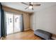 A bedroom with hardwood flooring featuring a sliding door that leads to a covered patio at 12448 N 76Th St, Scottsdale, AZ 85260