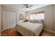 Bedroom with wood floors features a large closet and a window for natural light at 12448 N 76Th St, Scottsdale, AZ 85260