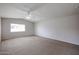 Spacious bedroom features neutral carpet, ceiling fan, vaulted ceiling, and ample natural light at 12448 N 76Th St, Scottsdale, AZ 85260