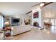 Bright living room with high ceilings, fireplace, built-in shelving, and open access to the dining area at 12448 N 76Th St, Scottsdale, AZ 85260