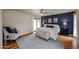 Stylish main bedroom with accent wall, access to the outdoors, and a cozy seating area at 12448 N 76Th St, Scottsdale, AZ 85260