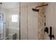 Close-up of a tiled shower with a rainfall showerhead and glass door at 12448 N 76Th St, Scottsdale, AZ 85260