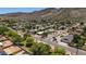Aerial view of neighborhood surrounded by a desert landscape and rolling mountains at 12835 N 16Th Dr, Phoenix, AZ 85029