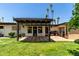 Backyard featuring a covered patio, green grass, and manicured landscaping at 12835 N 16Th Dr, Phoenix, AZ 85029