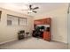 Bedroom with carpet, ceiling fan and a large wooden desk at 12835 N 16Th Dr, Phoenix, AZ 85029