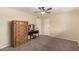 Carpeted bedroom featuring a dresser and makeup vanity at 12835 N 16Th Dr, Phoenix, AZ 85029