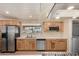 Well-lit kitchen with wood cabinetry, stainless steel appliances, and ample counter space at 12835 N 16Th Dr, Phoenix, AZ 85029