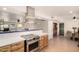 Bright kitchen featuring a stainless steel gas range and custom wood cabinetry at 12835 N 16Th Dr, Phoenix, AZ 85029