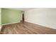 Spacious room with hardwood floors and view into adjacent room at 12835 N 16Th Dr, Phoenix, AZ 85029
