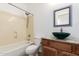 Bathroom features a shower-tub combo and wood vanity with a marble countertop and green sink at 12950 W Alegre Dr, Litchfield Park, AZ 85340