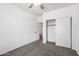 Bedroom with carpet and closet space with a view into another room at 12950 W Alegre Dr, Litchfield Park, AZ 85340