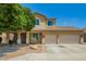 Inviting two-story home with a two-car garage, desert landscaping, and charming front porch at 12950 W Alegre Dr, Litchfield Park, AZ 85340
