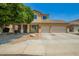 Inviting two-story home with a two-car garage, desert landscaping, and charming front porch at 12950 W Alegre Dr, Litchfield Park, AZ 85340