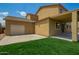 Well-maintained home with a two-car garage, covered patio, and verdant lawn at 12950 W Alegre Dr, Litchfield Park, AZ 85340