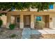 Welcoming front entrance with a covered porch, desert landscaping, and a stylish front door at 12950 W Alegre Dr, Litchfield Park, AZ 85340