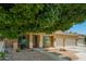 Attractive home with a two-car garage, desert landscaping, and covered front porch at 12950 W Alegre Dr, Litchfield Park, AZ 85340