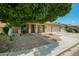 Attractive home with a two-car garage, desert landscaping, and covered front porch at 12950 W Alegre Dr, Litchfield Park, AZ 85340