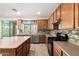 Lovely kitchen with stainless appliances, kitchen island, and backyard access at 12950 W Alegre Dr, Litchfield Park, AZ 85340