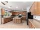 Large kitchen with center island, stainless appliances, and ample cabinetry at 12950 W Alegre Dr, Litchfield Park, AZ 85340