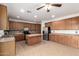 Spacious kitchen with stainless steel appliances, center island, and tile floors at 12950 W Alegre Dr, Litchfield Park, AZ 85340