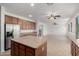 Spacious kitchen flows into the living area, stainless appliances, and large island at 12950 W Alegre Dr, Litchfield Park, AZ 85340