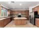 Charming kitchen featuring center island, tile backsplash, and stainless appliances at 12950 W Alegre Dr, Litchfield Park, AZ 85340